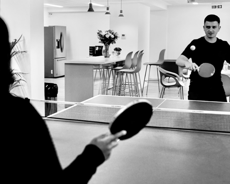 Photo of people playing ping pong in the office